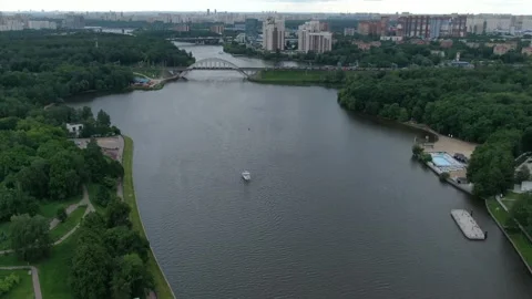 Aerial pullback over river and urban district Stock Footage 332684136