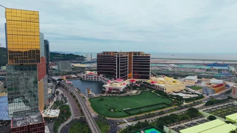 Aerial Pullback Over Wynn Palace and MGM Cotai Revealing Cotai Leste Tram Line Video stock 334767790