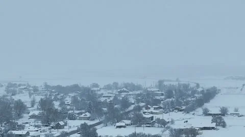 Aerial-Pullback-Overcast-snowing on small rural town Stock Footage 266962919
