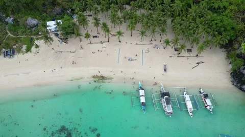 Aerial pullback parallax palawan beach with outrigger canoes reveals Stock Footage 245411855