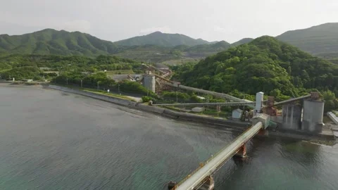 Aerial pullback on pier with conveyor for loading bulk materials on ships Stock Footage 242461447