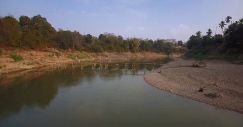 Aerial Pullback Reveal Of Bamboo Bridge Over Nam Khan River, Luang Prabang, Laos Stock Footage 80012397