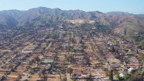 Aerial pullback reveal shot of Pacific Palisades in recovery after fire Stock Footage 308184489