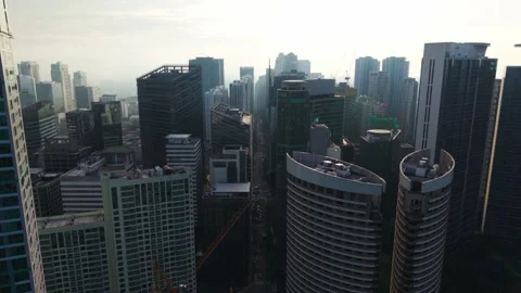 Aerial Pullback Reveals Dense High-Rise Towers Fading Into a Hazy Urban Skyline Stock Footage 345370377