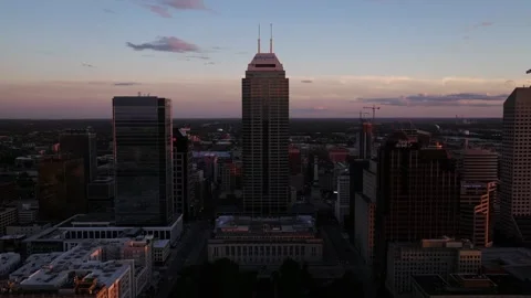 Aerial Pullback Reveals Downtown Indianapolis skyline at sunset on a summer Stock-Footage 317755220