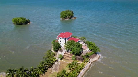 Aerial Pullback of Roca Encantada Heritage House Surrounded by Ocean in Video stock 334676837
