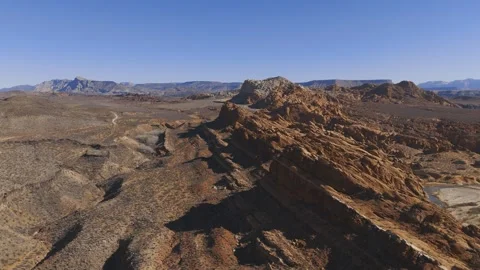 Aerial-Pullback-Rugged sandstonetilted layers Stock Footage 302323543
