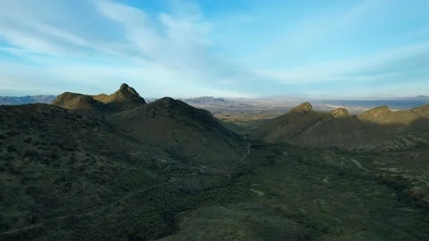 Aerial pullback of a scenic desert valley with rugged mountains Stock Footage 169525227