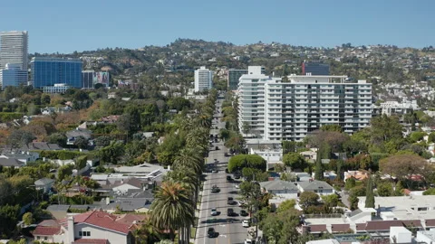 Aerial pullback shot of affluent Beverly Hills community and car traffic Stock Footage 273757739