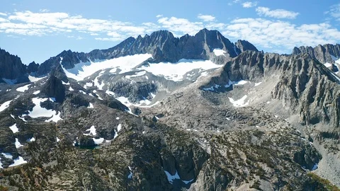 Aerial pullback shot of alpine mountains, lake, glaciers in Eastern Sierra Stock Footage 122857065