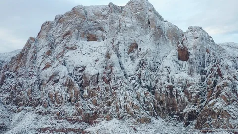 Aerial pullback shot of beautiful snow covered mountain range at Red Rock Canyon Stock Footage 122054845