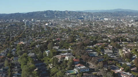 Aerial pullback shot of Beverly Hills suburban area in Los Angeles California Stock Footage 272690411