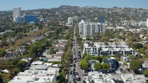 Aerial pullback shot of Beverly Hills streets, cars, condos, shops, palm trees Stock Footage 272700120