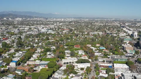 Aerial pullback shot of Beverly Hills and Hollywood suburban homes, buildings Stock Footage 272769324