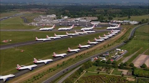 Aerial pullback shot of British Airways Aircraft parked up at Bournemouth Stock Footage 129928991
