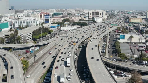 Aerial pullback shot of busy freeway car traffic in downtown Los Angeles Stock Footage 273746922