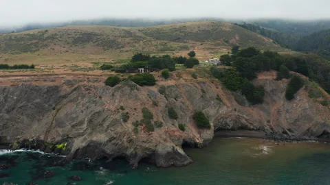 Aerial pullback shot of coastline house on Pacific Coast in Northern California Stock Footage 200775064