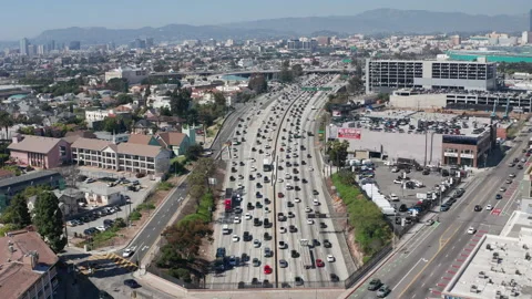 Aerial pullback  shot of crowded and busy Los Angeles urban highway traffic Stock Footage 273755552