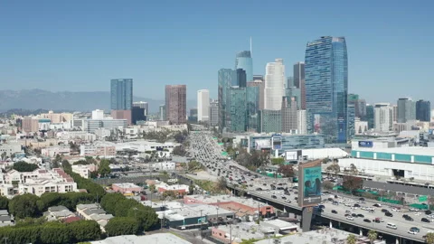 Aerial pullback shot of downtown Los Angeles, freeway car traffic, and buildings Stock Footage 273745823