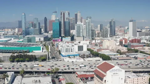 Aerial pullback shot of downtown Los Angeles, freeway car traffic, and buildings Stock Footage 273749036