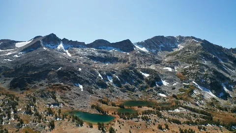 Aerial pullback shot of Eastern Sierra mountain peaks, glaciers, alpine lakes Stock Footage 122840358