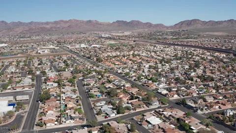 Aerial pullback shot of Henderson Las Vegas with mountains, cars, and trees Stock Footage 271276442
