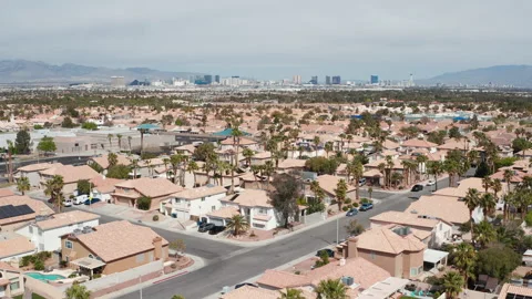 Aerial pullback shot of Henderson Las Vegas suburb, palm trees and city skyline Stock Footage 271355314