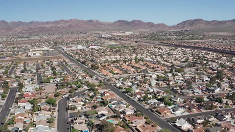 Aerial pullback shot of Henderson Nevada with mountains, cars, and trees Stock Footage 271275854