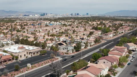 Aerial pullback shot of Henderson Nevada suburb with city skyline and roads Stock Footage 271355306
