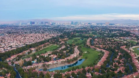 Aerial pullback shot of Las Vegas residential community, houses, golf course, Stock Footage 121819200