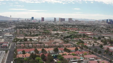 Aerial pullback shot of Las Vegas residential houses  with city skyline view Stock Footage 197648811