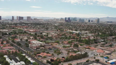 Aerial pullback shot  Las Vegas residential houses with city skyline Stock Footage 197667116
