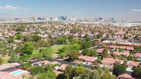 Aerial pullback shot of Las Vegas homes with casino strip skyline and airport Stock Footage 201564131