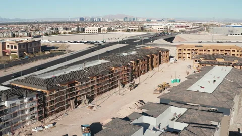 Aerial pullback shot of Las Vegas suburban residential construction with skyline Stock Footage 271151099