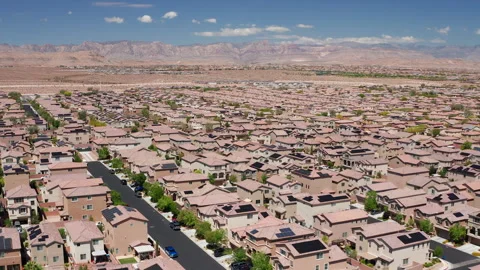 Aerial pullback shot of Las Vegas suburban desert homes with Red Rock Canyon Stock Footage 308819079