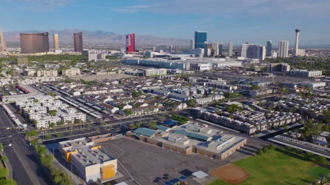 Aerial pullback shot of Las Vegas suburbs and Strip skyline and mountains Stock Footage 333485981