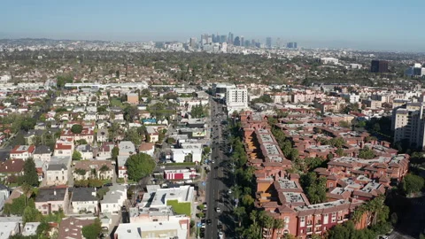 Aerial pullback shot of Los Angeles urban scenery and community and skyline Stock Footage 272772022