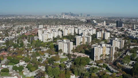 Aerial pullback shot of Los Angeles suburban neighborhood, trees, buildings Stock Footage 272778682