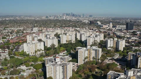 Aerial pullback shot of Los Angeles apartment community and downtown skyline Stock Footage 272778686
