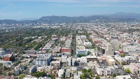 Aerial pullback shot of Los Angeles buildings, Hollywood sign, homes and hills Stock Footage 308103461