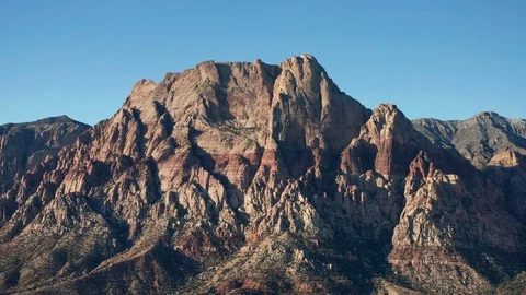 Aerial pullback shot of the massive Mount Wilson mountains in Red Rock Canyon Stock Footage 121228350