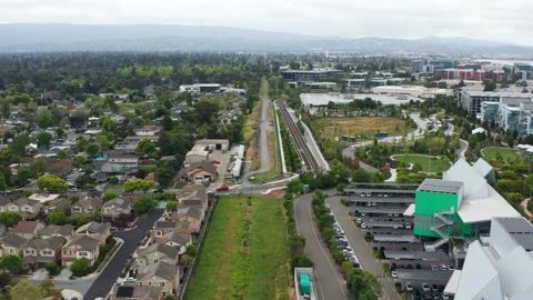 Aerial pullback shot of Menlo Park tech industry office buildings and homes Stock Footage 308253580