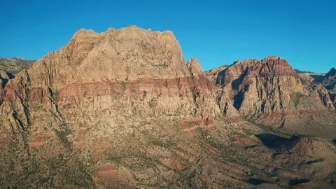 Aerial pullback shot of Red Rock Canyon Mountains, Mount Wilson and Rainbow Wall Stock Footage 122909658