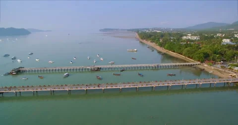 Aerial Pullback Shot Revealing Pier and Boats in Chalong Bay Phuket Video stock 63402941