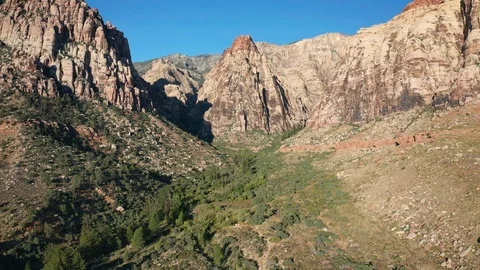 Aerial pullback shot of sandstone mountains, peaks, cliffs in Red Rock Canyon Stock Footage 122916976