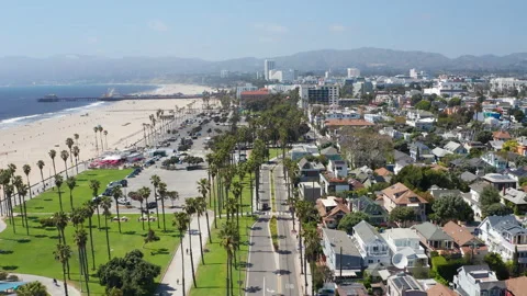 Aerial pullback shot of Santa Monica Los Angeles beach coast, palm trees, homes Stock Footage 308123329