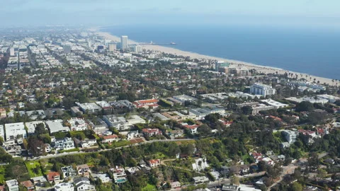 Aerial  pullback shot of Santa Monica Los Angeles homes beach coast ocean trees Stock Footage 308186972