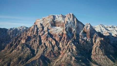 Aerial pullback shot of snow covered Mount Wilson mountains in Red Rock Canyon Stock Footage 120617557