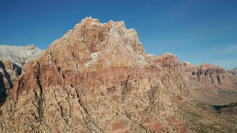 Aerial pullback shot of snow covered Mount Wilson mountains in Red Rock Canyon Video stock 120617627