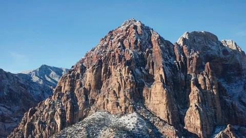Aerial pullback shot of snow covered Rainbow Wall mountains in Red Rock Canyon Video stock 120618038